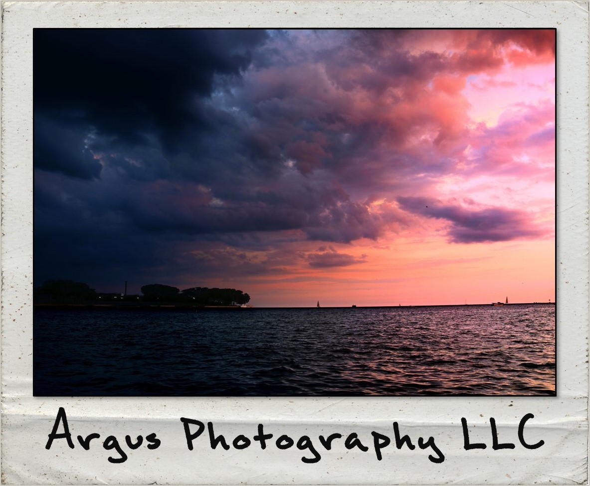 A polaroid of clouds over a lake. On the picture is written 'Argus Photography LLC'