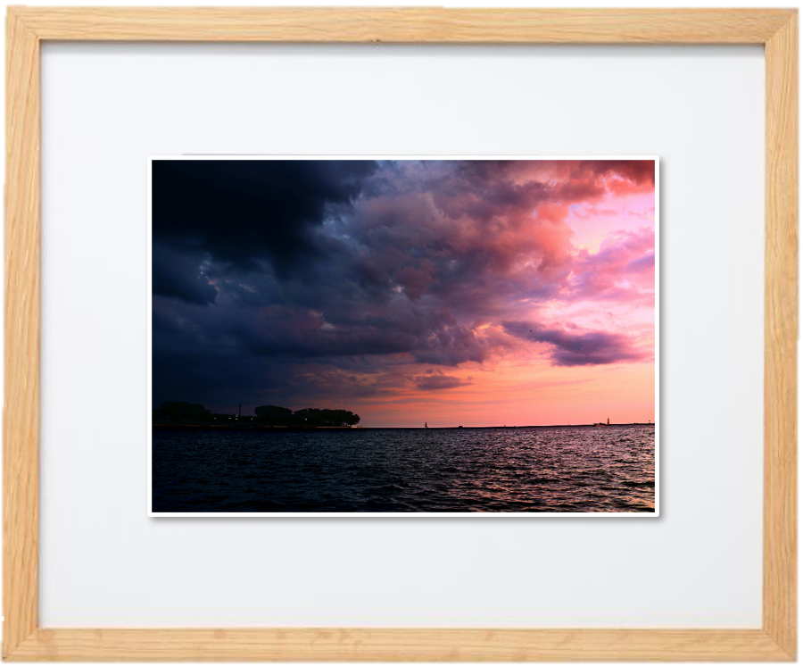 A framed image of clouds over a lake